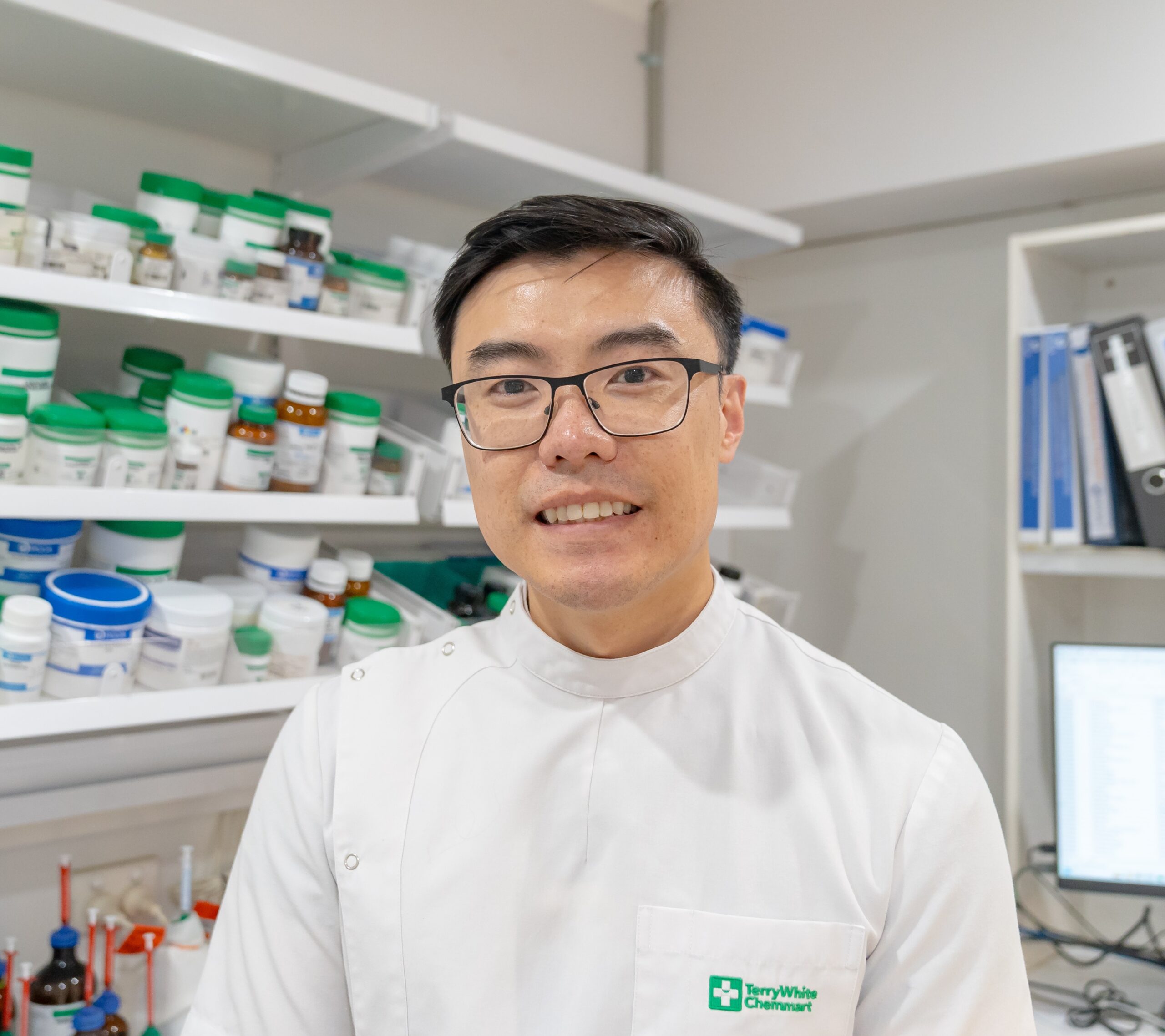 Community compounding chemist providing compounded medications, prescriptions, and supplements. Pharmacist at compounding chemist preparing prescription medicines, vitamins and supplements in a community pharmacy.